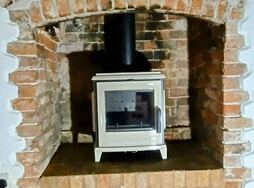 Exe Valley Stoves installation of an Invicta Sedan in Ivory